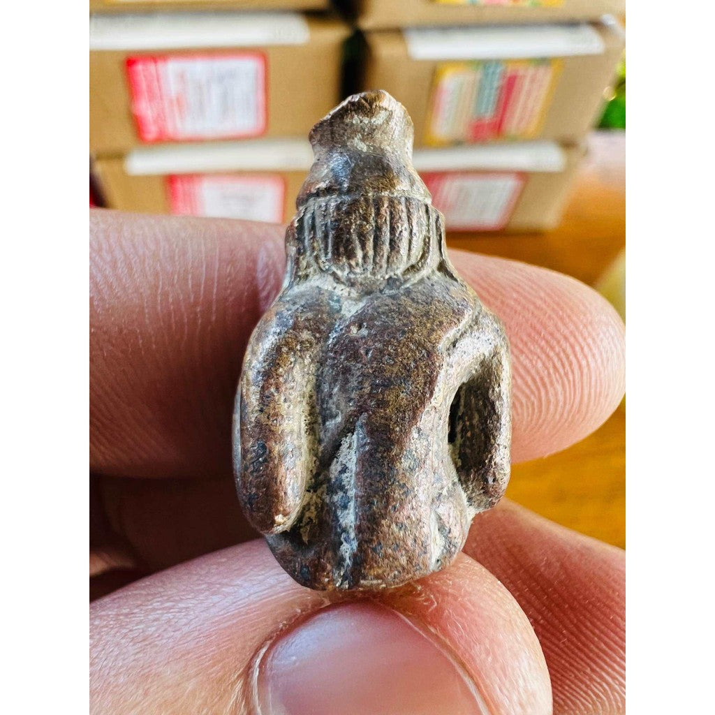 ancient protection amulet limited edition held between fingers showing detailed weathered surface