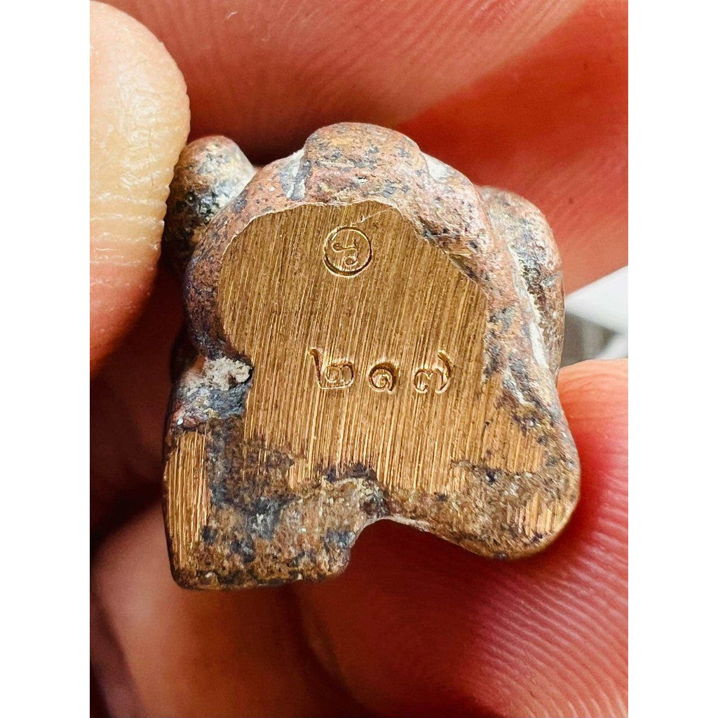Close-up of ancient protection amulet limited edition held between fingers with intricate markings