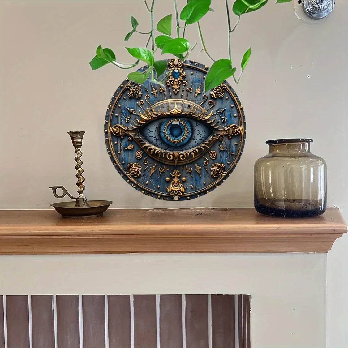 Eye of Horus metal wall sign ornate blue and gold eye medallion hanging above mantel with plant