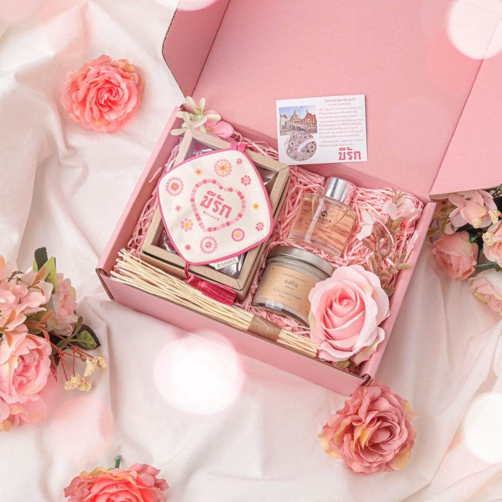 One-Sake.com aromatherapy wedding gift box with scented candle, diffuser sticks, perfume, and pink floral decor