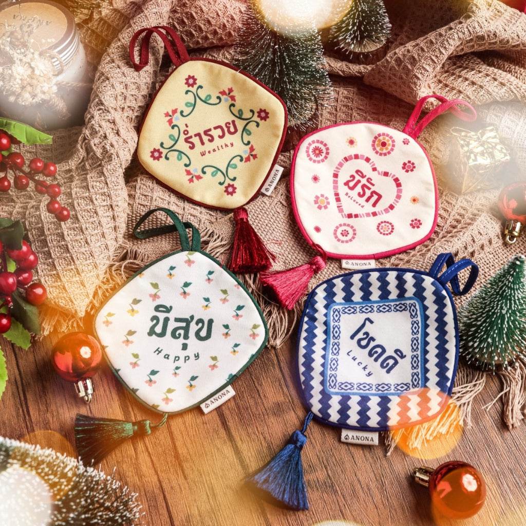 One-Sake.com aromatic sachet collection for home with colorful Thai design and tassels on wooden surface