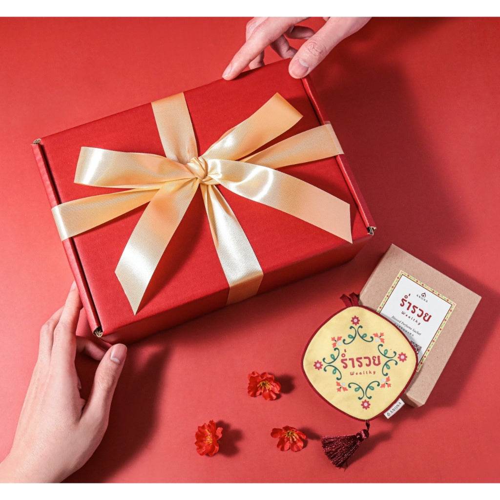 Cherry aroma gift set with red gift box tied with gold ribbon and decorative items on red background