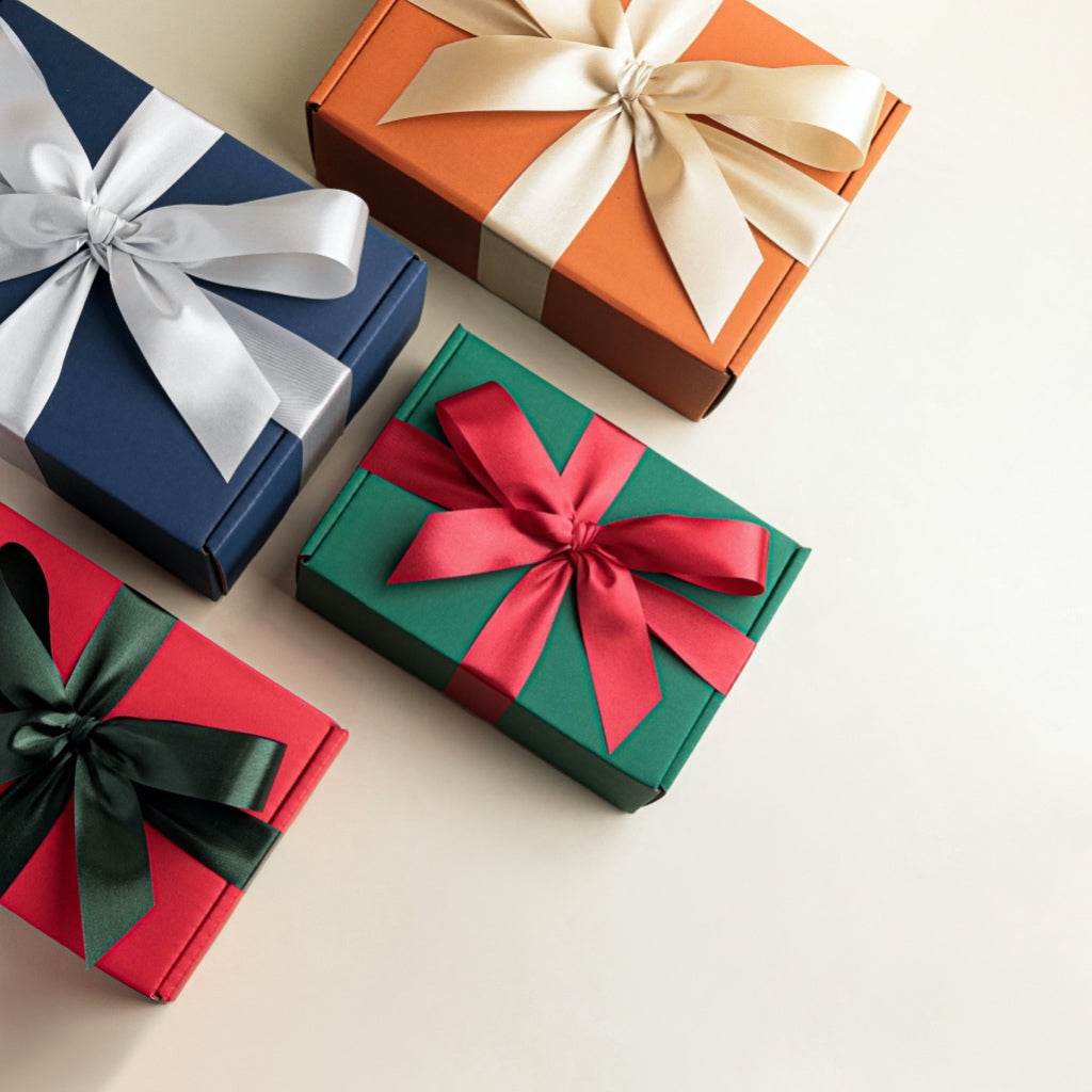 Christmas aromatherapy gift set with colorful wrapped boxes featuring red green blue and orange ribbons
