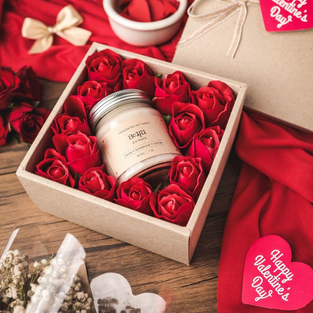 Customizable Valentine's Day gift set with scented candle surrounded by red rose decorations in a gift box