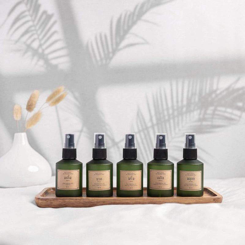 Herbal aromatherapy gift set with five green spray bottles on wooden tray by One-Sake.com