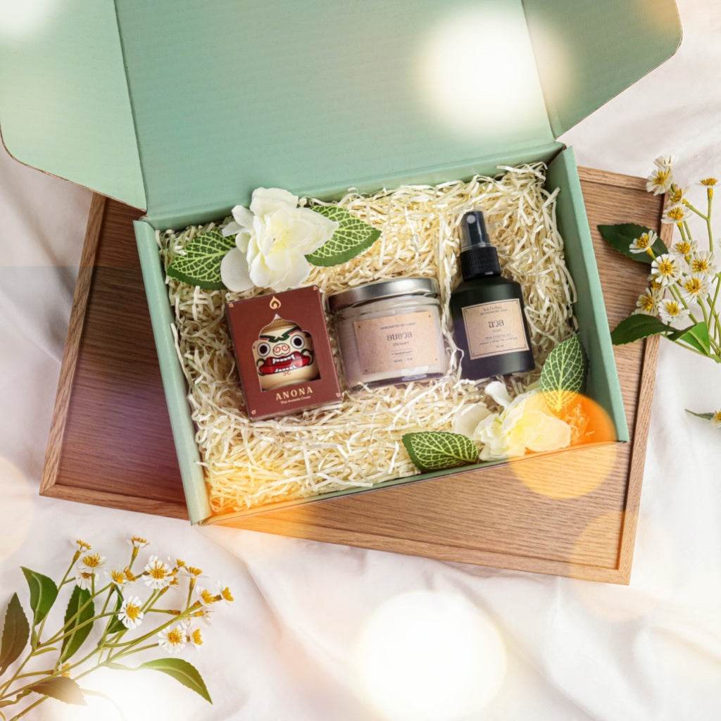 Herbal balm soy candle gift box with natural skincare products in a green box with decorative flowers