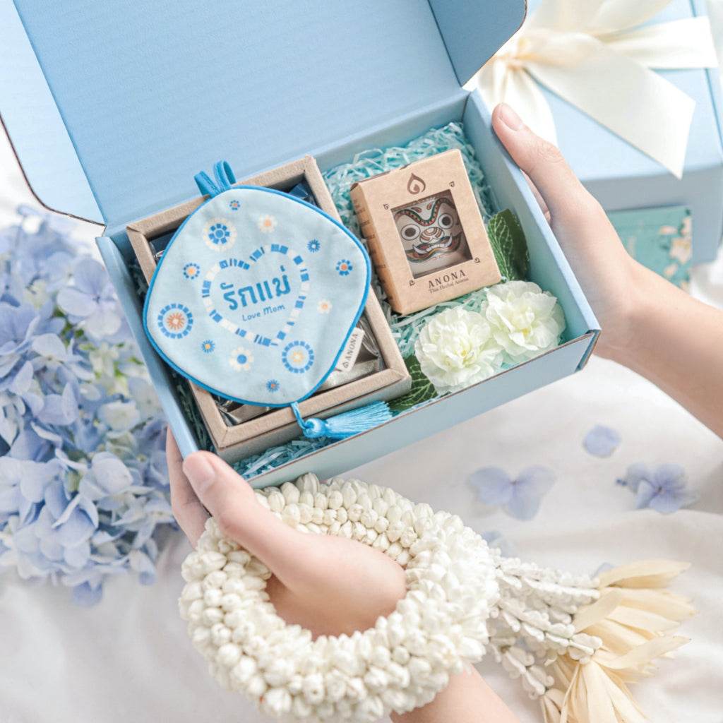 Herbal sachet and diffuser gift for mom in a blue gift box with floral decorations and white flowers
