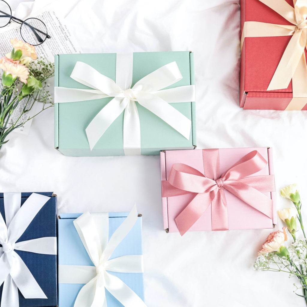 Assorted pastel gift boxes wrapped with ribbons featuring lucky scent sachet and room spray for mothers