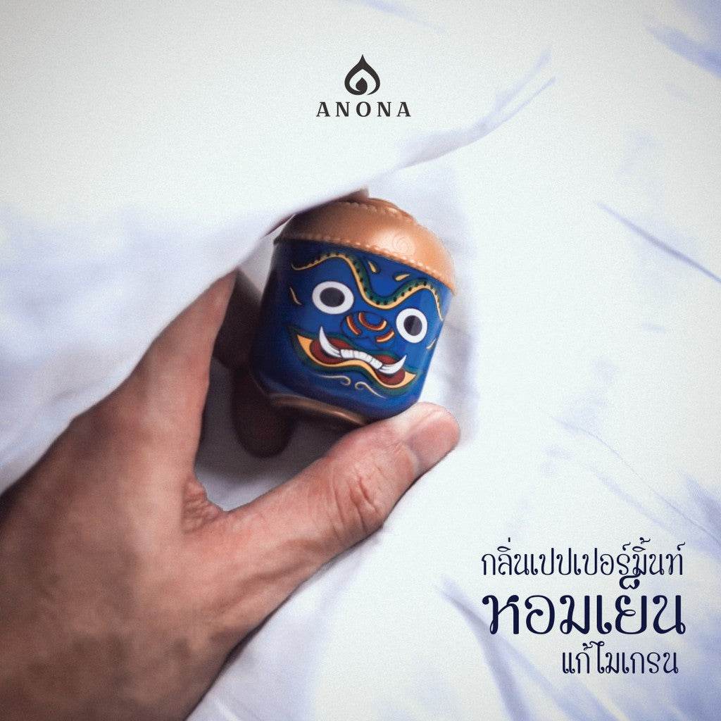 Hand holding a blue and copper natural aroma box set for adults with decorative face design
