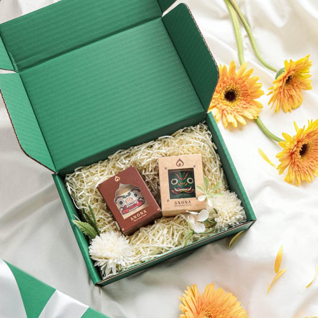 Natural essential oil diffuser set in green gift box with decorative flowers and straw packing