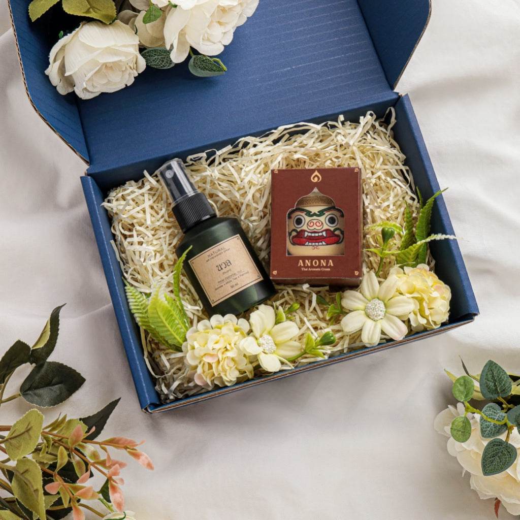 Natural herbal gift set in blue box with spray bottle, scented candle, and decorative flowers