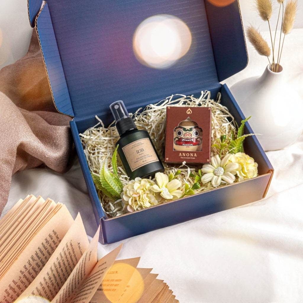 Natural herbal gift set in blue box with spray bottle, decorative flowers, and Anona incense pack