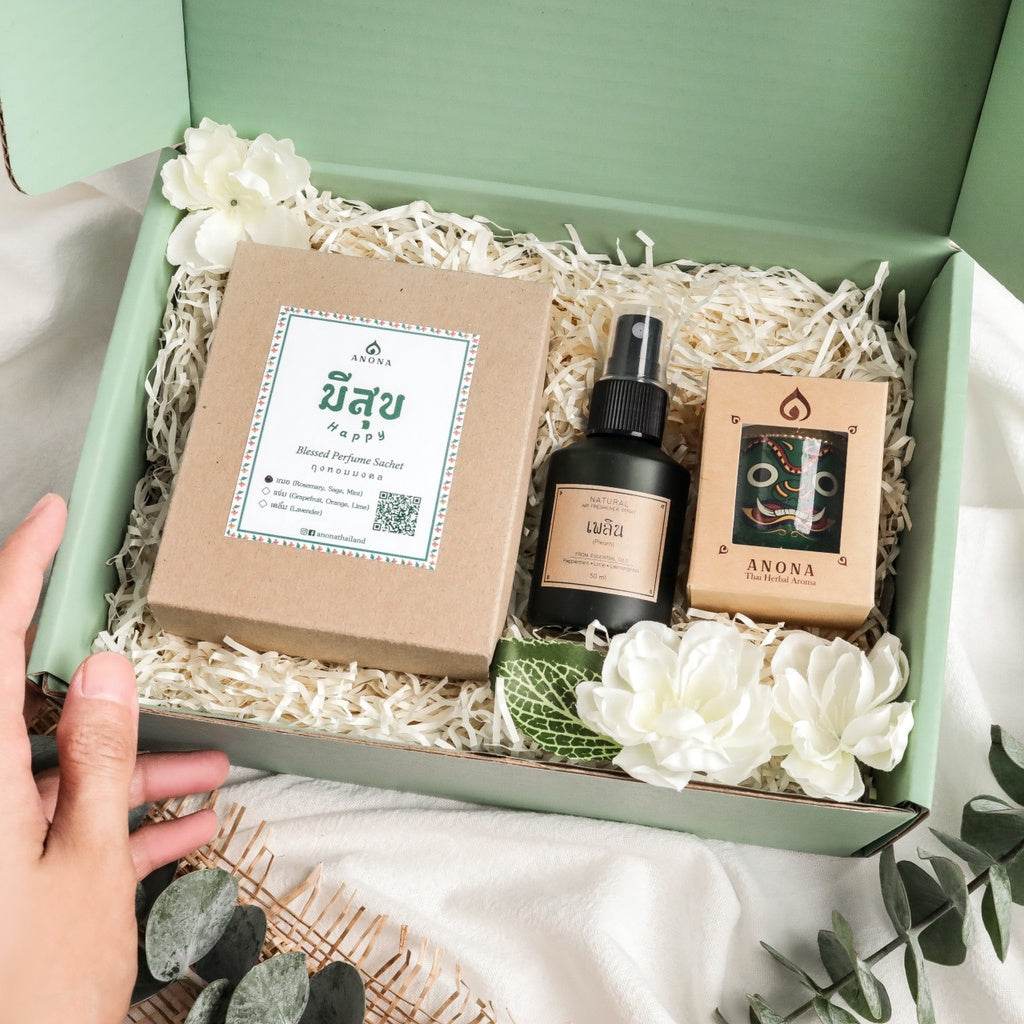 Pastel green aromatherapy gift set including perfume sachet, spray bottle, and decorative flowers in a green gift box