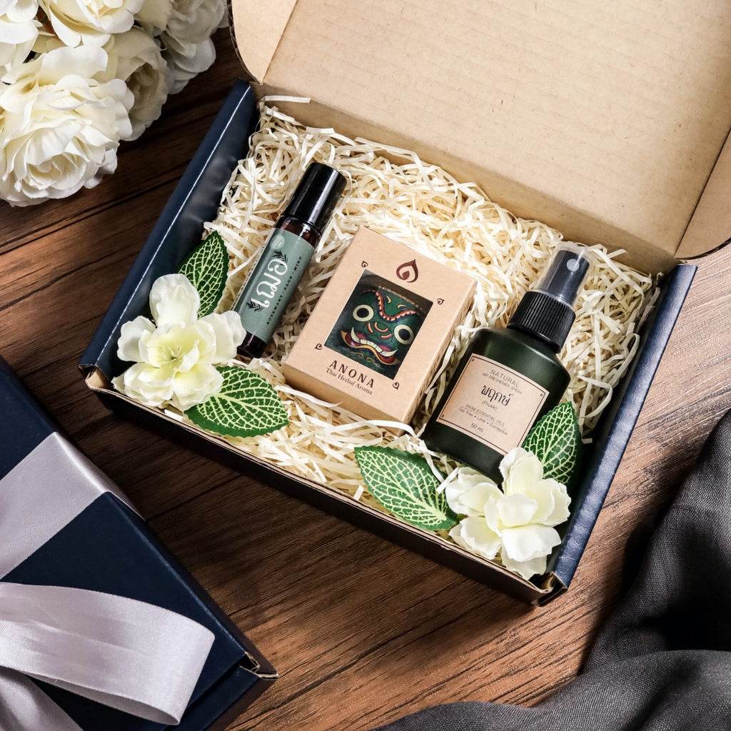 Premium Thai gift box for adults with natural beauty products and decorative flowers in a wooden background
