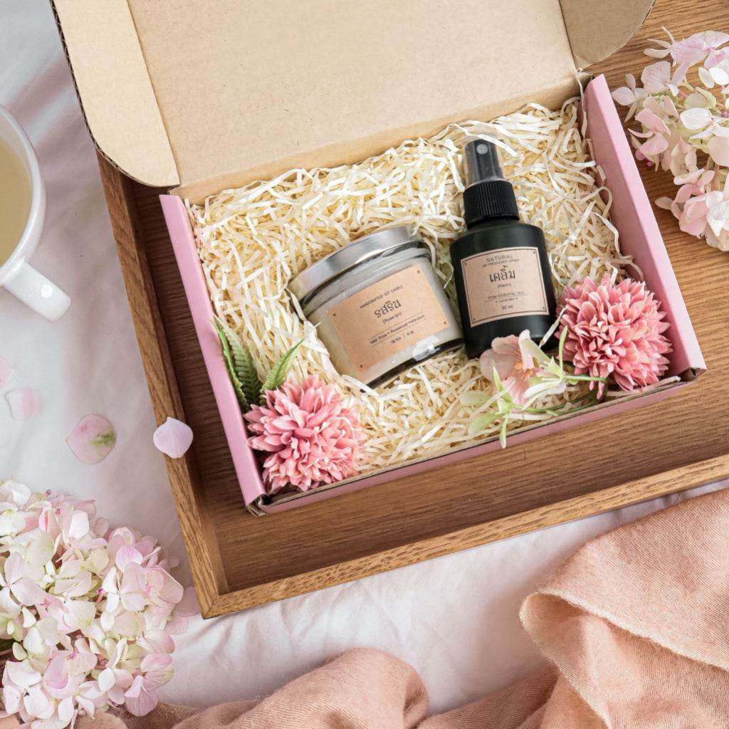 Romantic aromatherapy gift set with scented candle and spray in a pink box with flowers