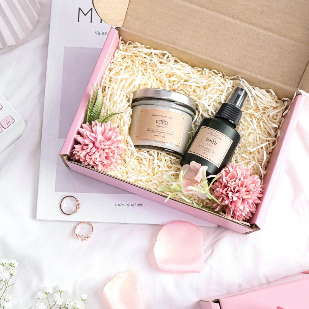 Romantic aromatherapy gift set with scented candle and spray in pink gift box with flowers