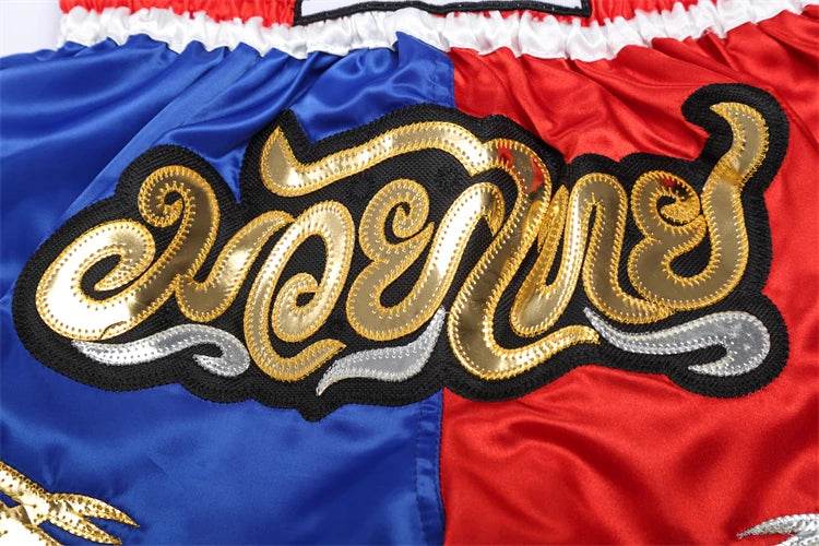 Muay Thai boxing shorts blue and red satin with gold embroidered Thai script and elastic waistband