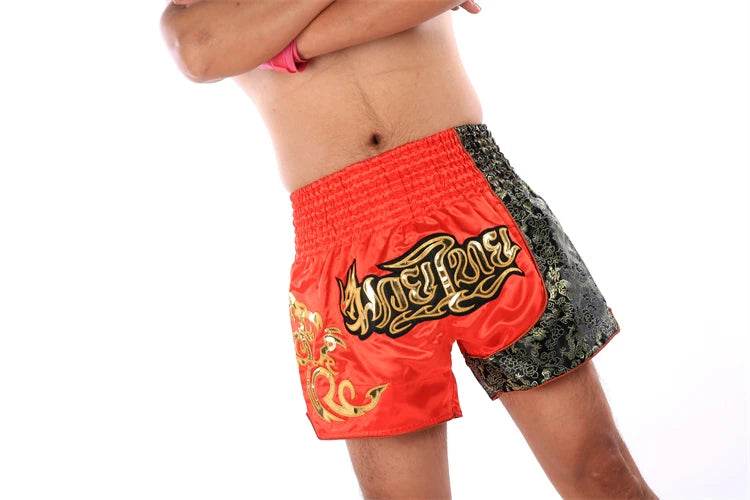 Thai Blessing Co Muay Thai boxing shorts red and black with gold embroidered Thai script for training