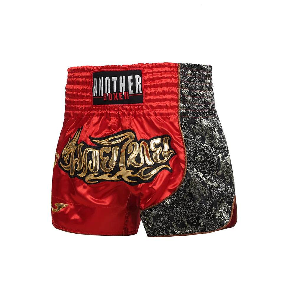 Red and black satin Muay Thai boxing shorts with gold Thai script embroidery and wide elastic waistband