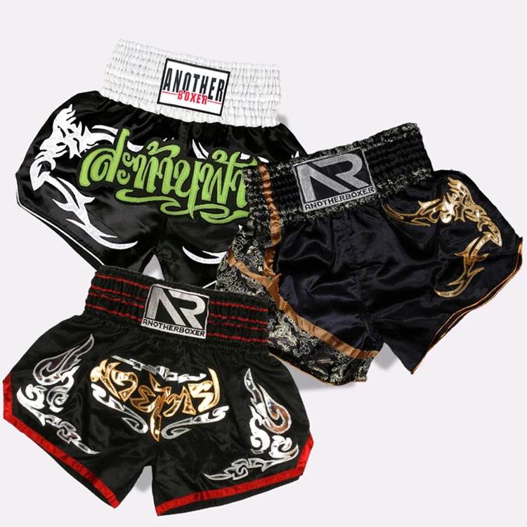 Muay Thai boxing shorts set of three black satin trunks with gold green and white tribal designs