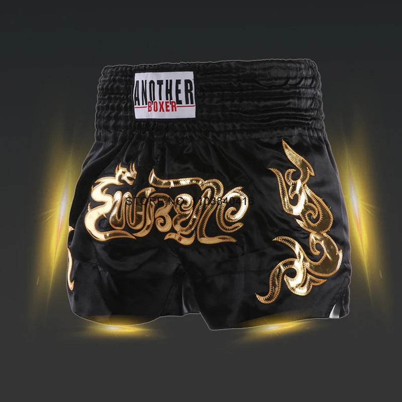 Black satin kickboxing trunks for men and women with gold Thai dragon embroidery and wide elastic waistband