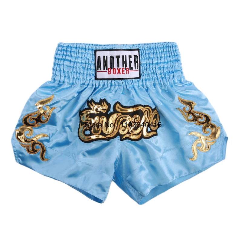 Light blue satin kickboxing trunks for men and women with gold embroidered dragon design and elastic waistband