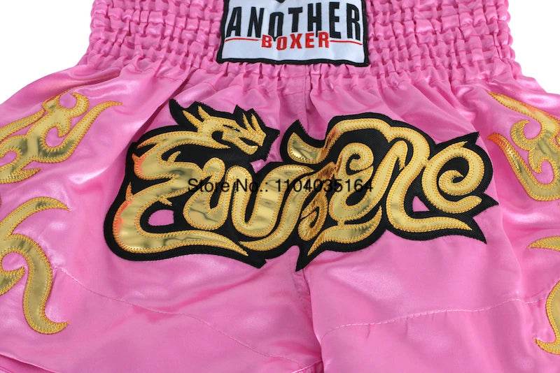 satin kickboxing trunks for men and women pink with gold embroidered dragon design and elastic smocked waistband