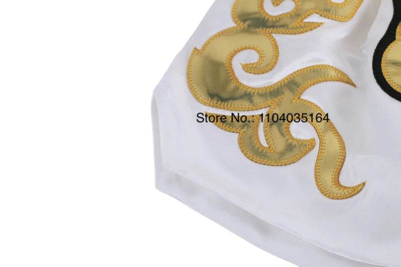 White satin kickboxing trunks for men and women with gold flame embroidery detail by Thai Blessing Co