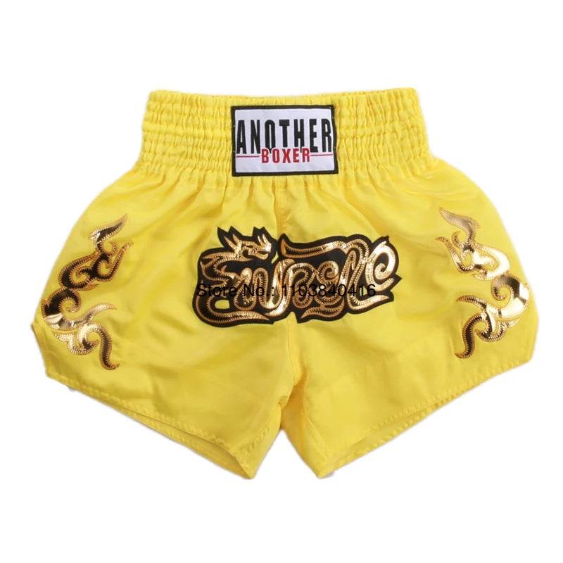 Yellow embroidered satin kickboxing trunks for men and women with elastic waistband and gold motifs