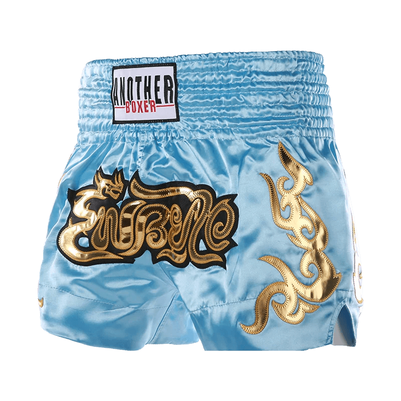 Light blue satin Muay Thai shorts unisex with gold embroidered Thai script and elastic high waistband