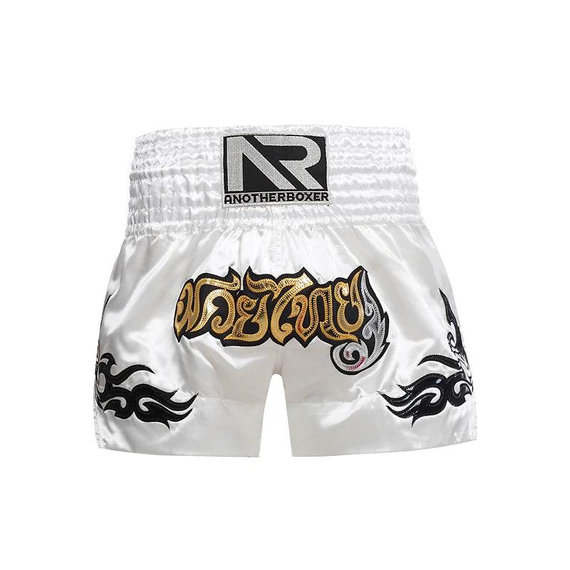 White satin Muay Thai shorts unisex with gold Thai script black flame side designs and wide elastic waistband