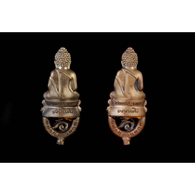 Attamano 9 auspicious Buddha amulet set bronze Buddha amulets displayed back view side by side on black background