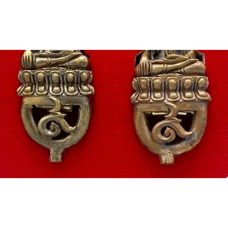 Attamano 9 auspicious Buddha amulet set brass lower Buddha motifs on red background close up detail