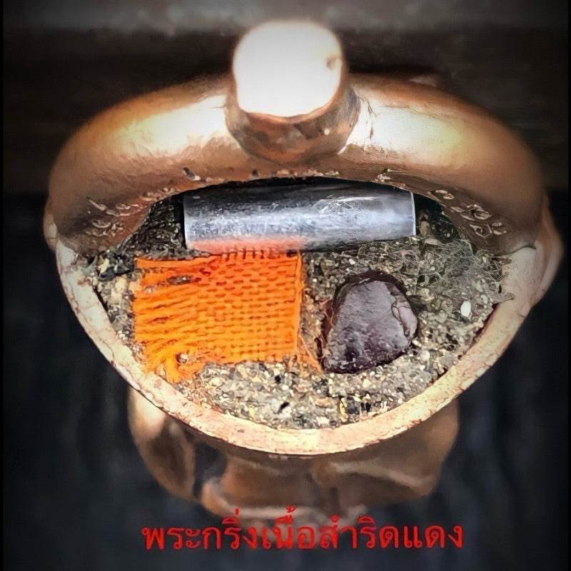 Attamano 9 auspicious Buddha amulet set showing open brass amulet cavity with orange cloth relic and metal tube