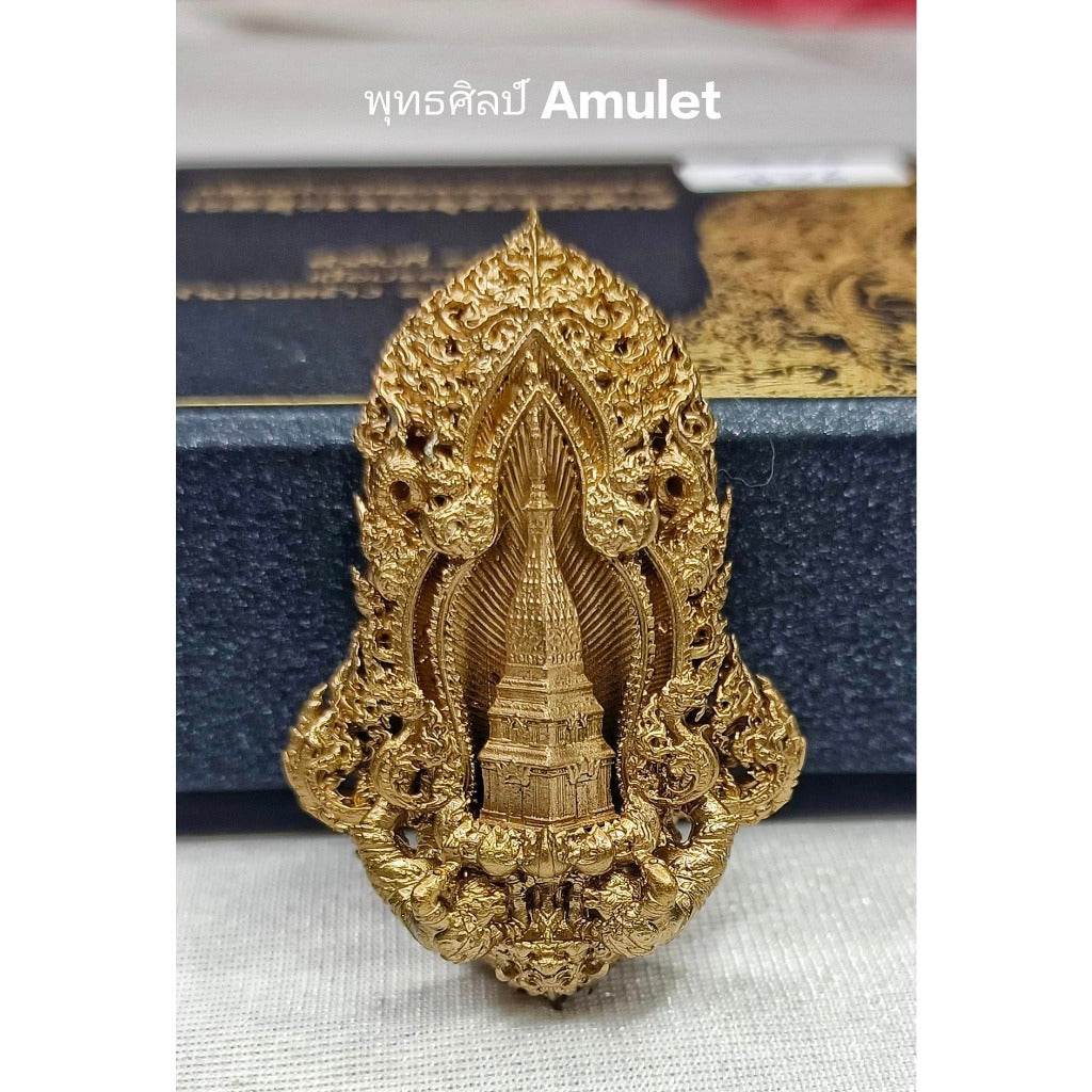 Intricately designed authentic Thai blessed amulet in gold with detailed temple engraving