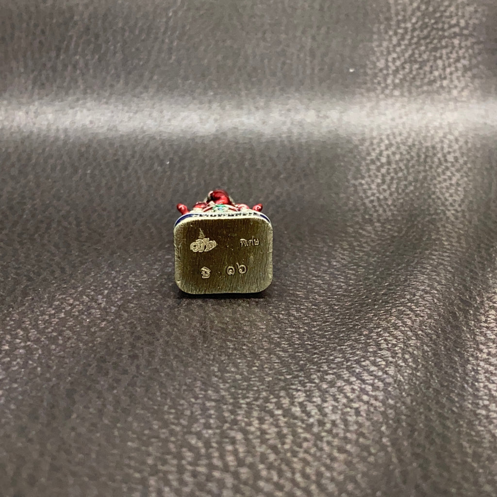 Authentic Thai Ganesha amulet with detailed engraving and decorative red accents