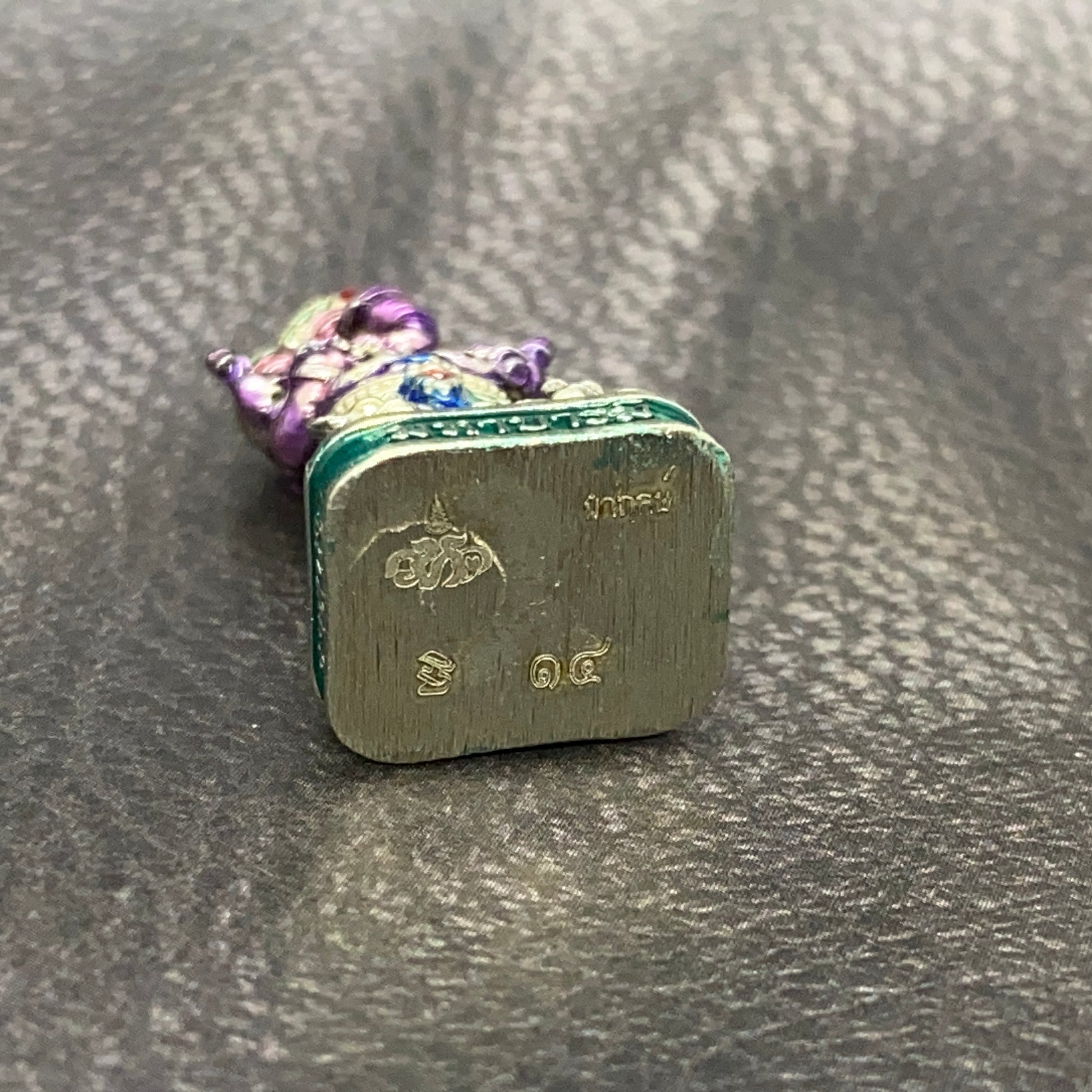 Authentic Thai Ganesha amulet with detailed craftsmanship and vibrant colors, showcasing Thai culture