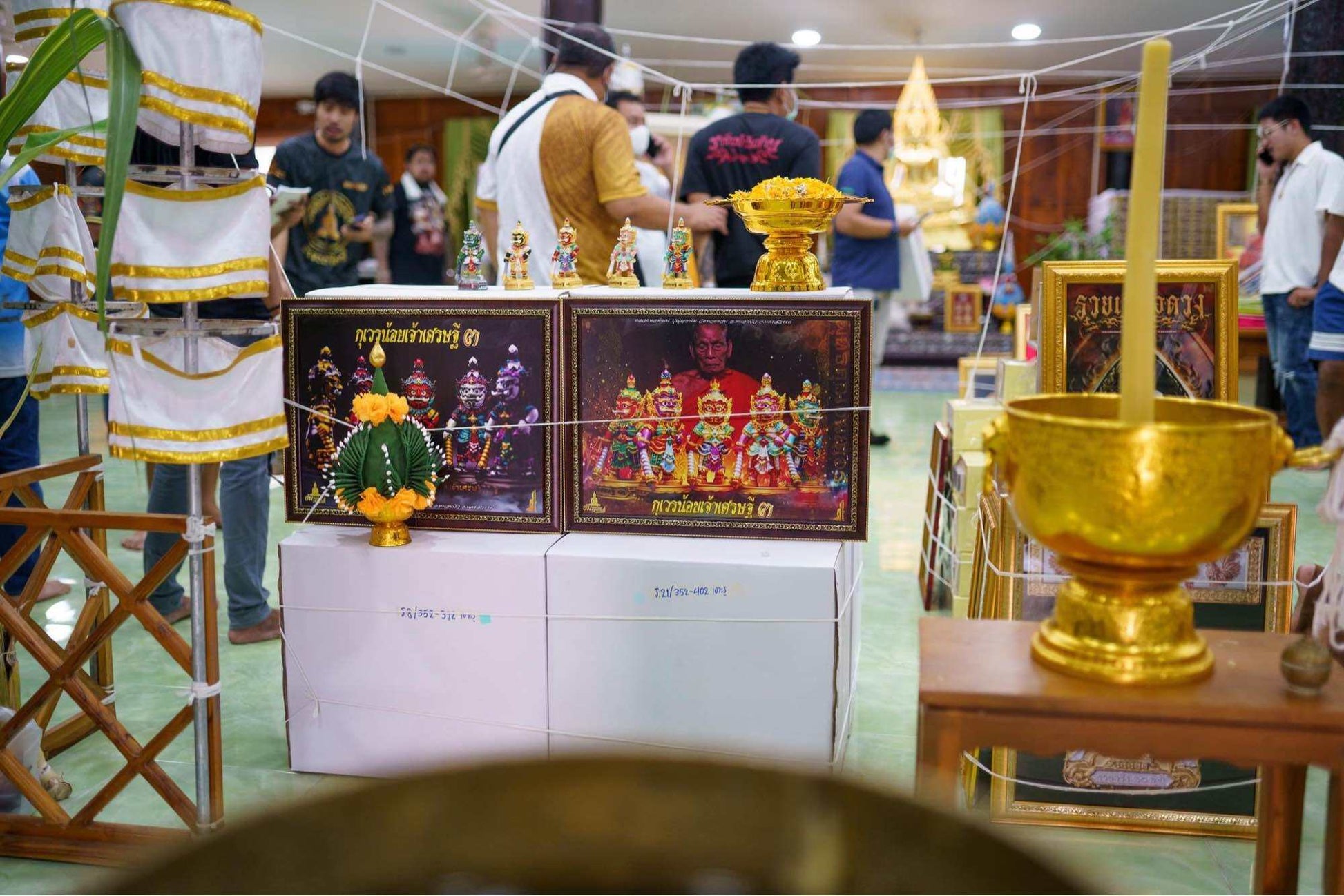 Display of authentic Thai lucky charm for prosperity in a shrine setting with cultural artifacts