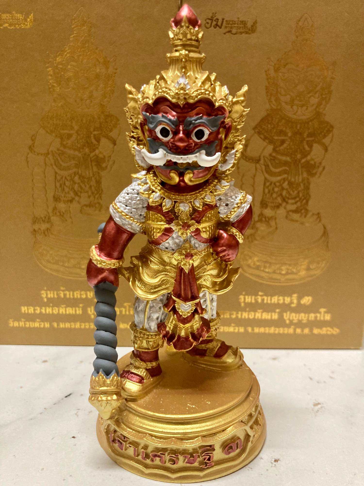 Colorful authentic Thai lucky charm for prosperity figurine with intricate details and a golden base