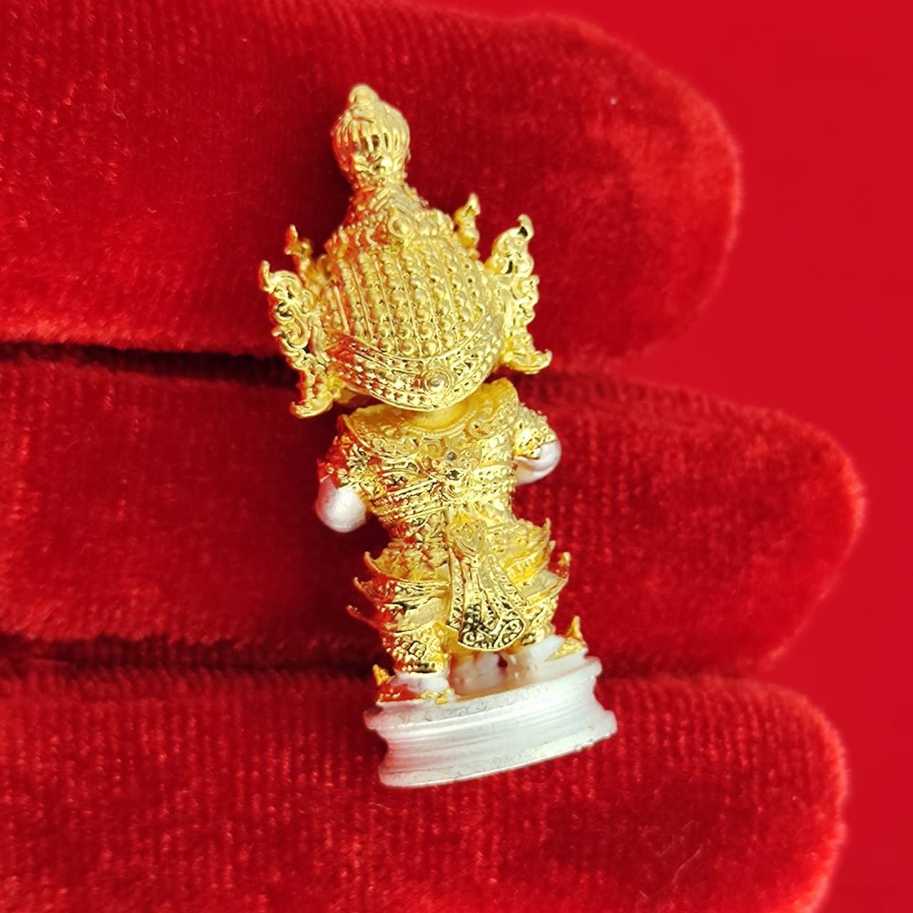 Authentic Thai protective amulet featuring intricate gold detailing for spiritual protection