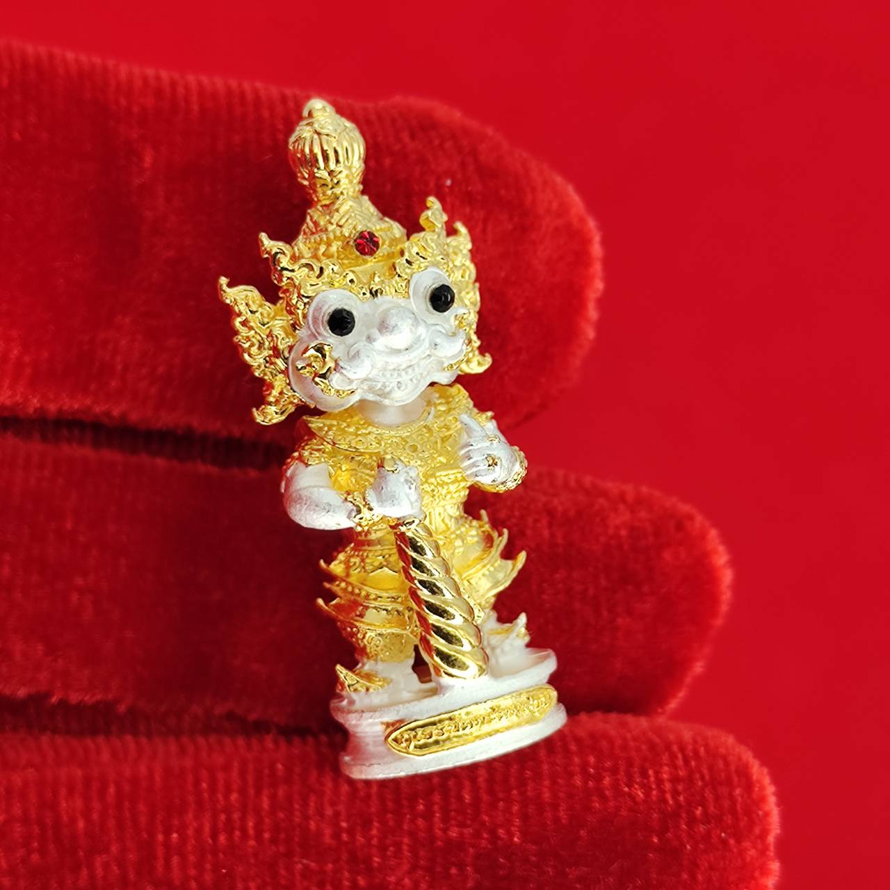 Authentic Thai protective amulet depicting a guardian deity with intricate gold details