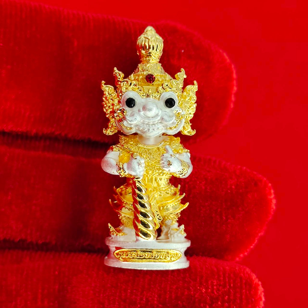 Authentic Thai protective amulet featuring a detailed gold and white figure with intricate designs