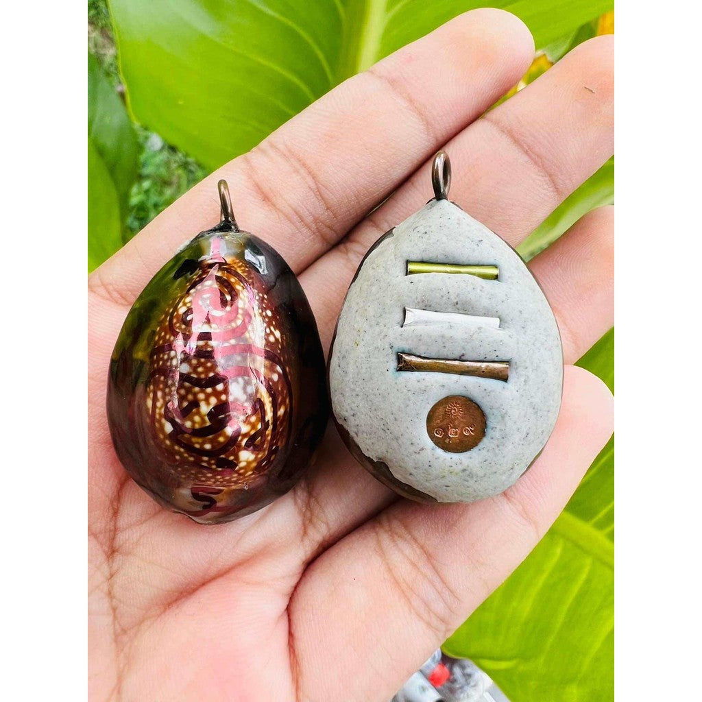 Bai Kae Supreme Protection amulet with intricate design shown front and back in hand by Thai Blessing Co