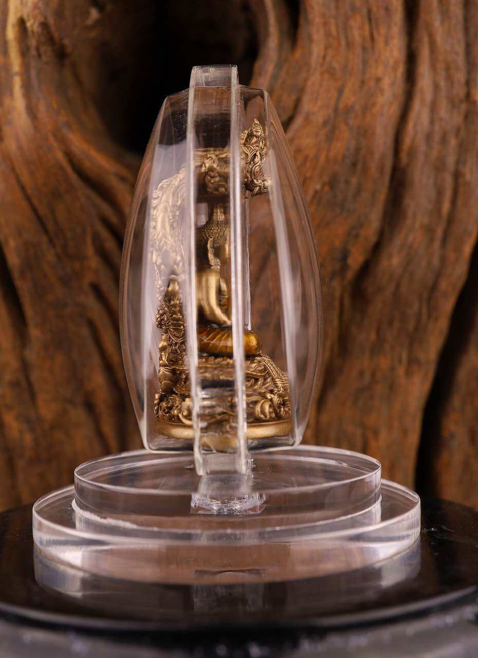 Phra Nak Prok statue bronze pendant in clear acrylic case on display base for devotional wear