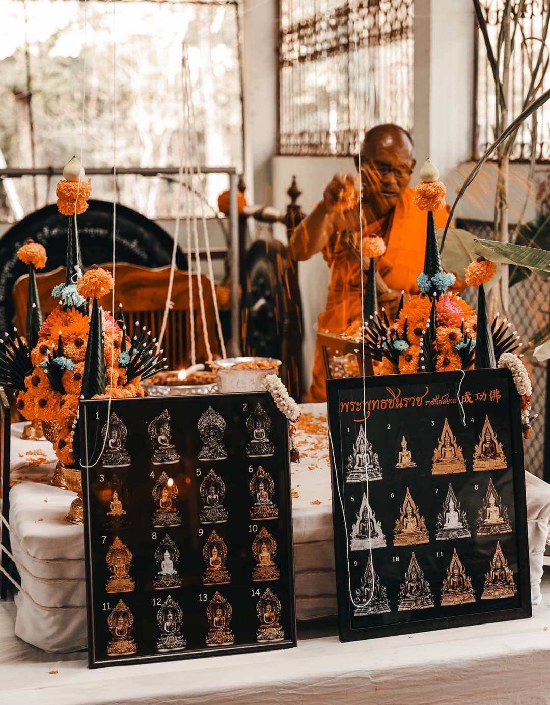 Phra Nak Prok statue bronze amulet display with garlands and monk blessing ceremony by Thai Blessing Co