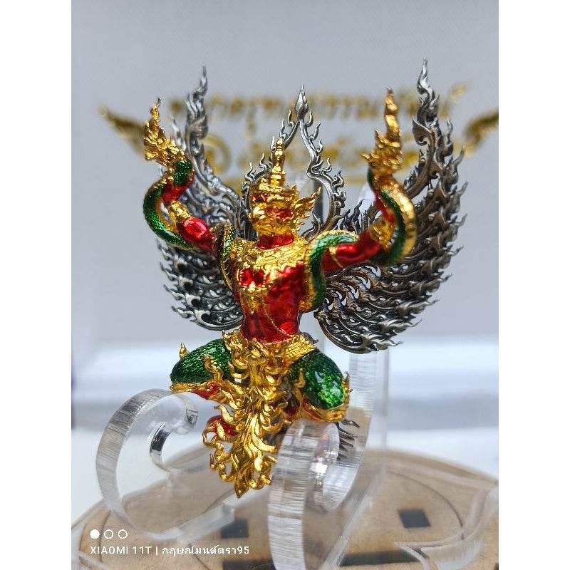 Blessed Thai talisman for wealth in red green and gold with intricate winged design by Thai Blessing Co