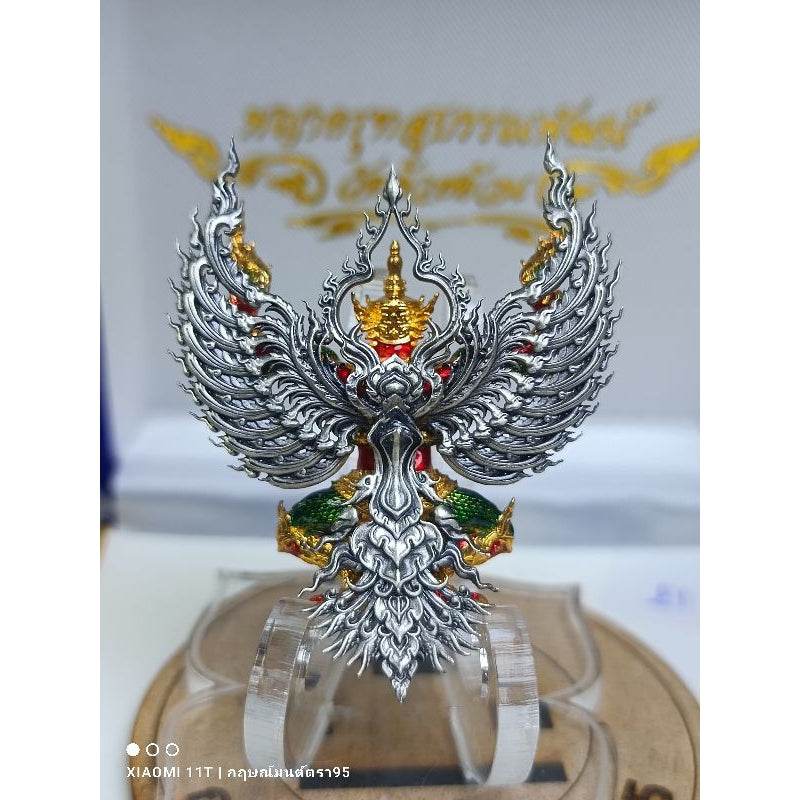 Intricate blessed Thai talisman for wealth featuring detailed silver wings and gold accents