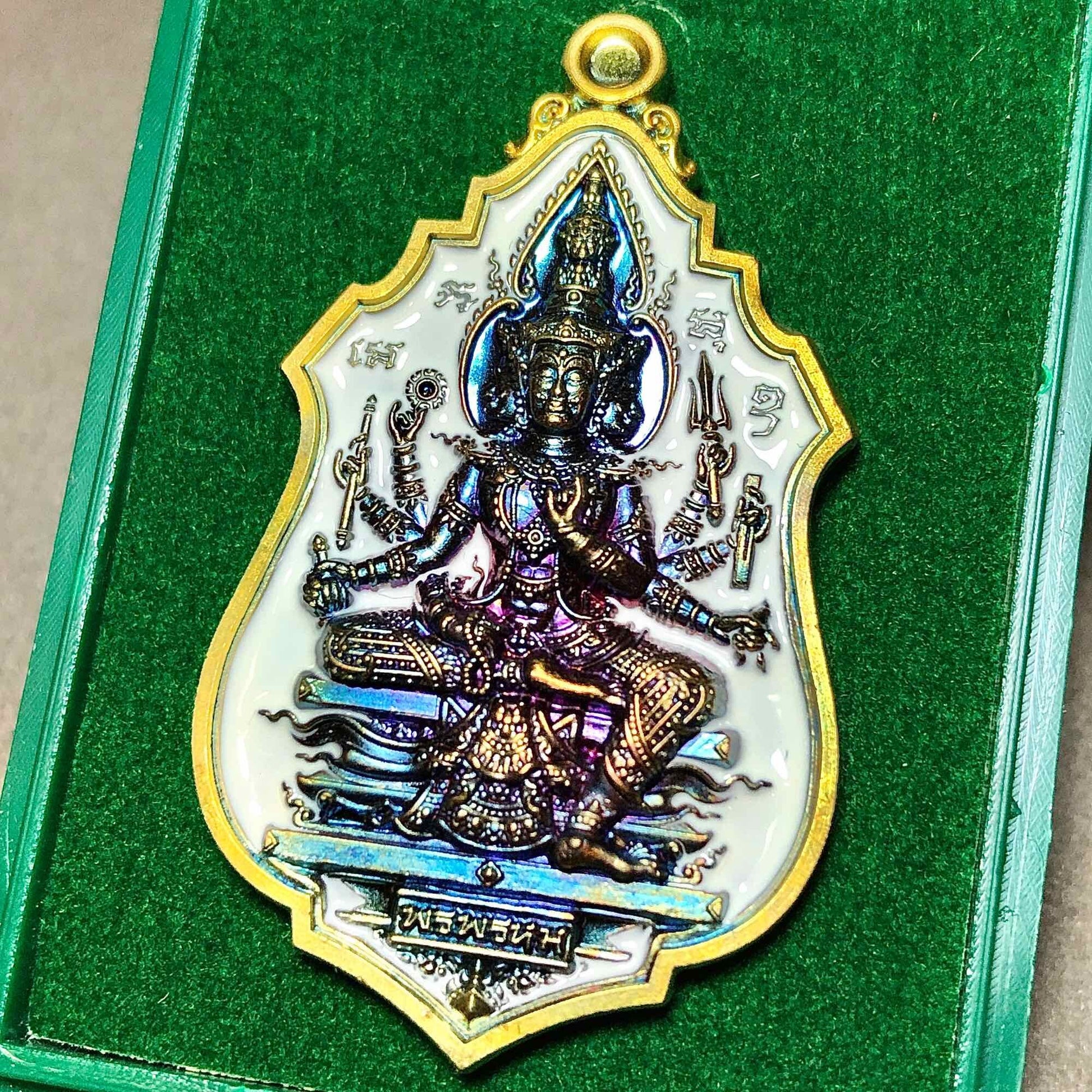 Brahma blessing amulet Thailand featuring an intricate design and vibrant colors in a protective casing
