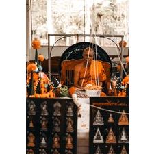 Buddhist protection amulet Thailand displayed with orange flowers and monks in serene setting
