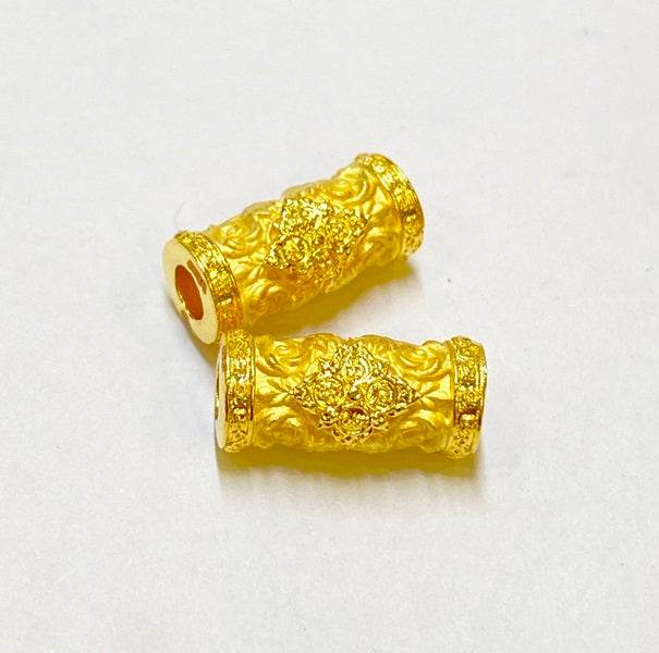 Two golden Thai talismans featuring intricate designs symbolizing charm and attraction Thai talisman